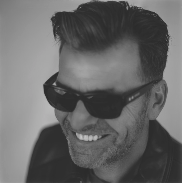 man with great haircut smiling wearing sunglasses